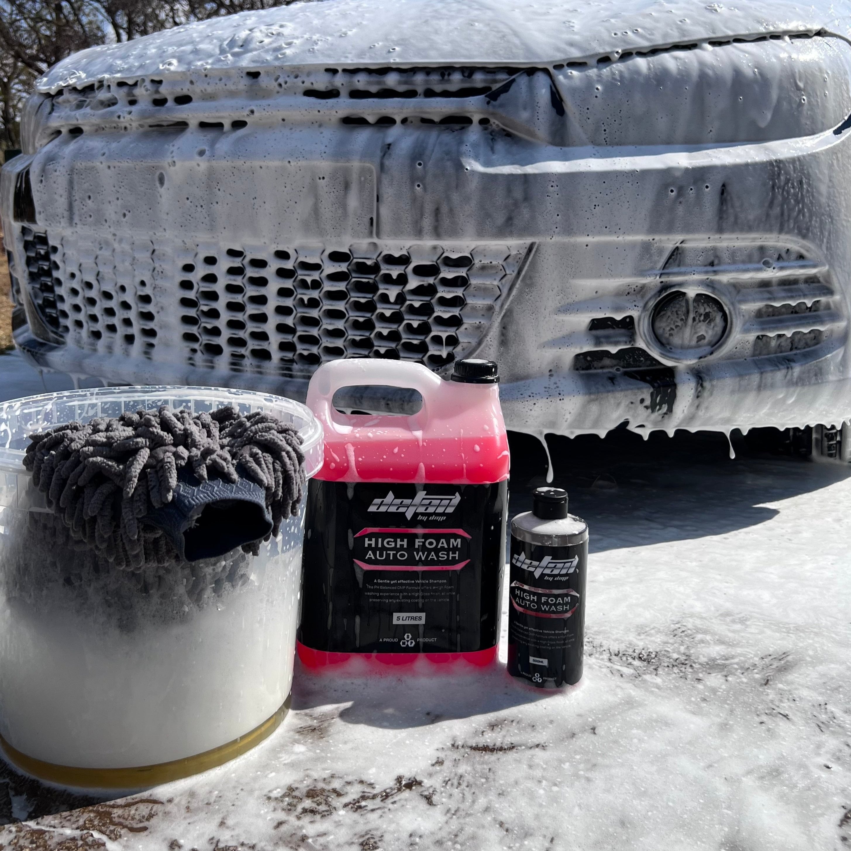 High Foam Wash and Wax 500ml and 5 litre, front of car, with bucket filled with thick foam and wash mitt