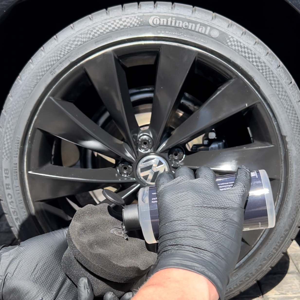 Clear Gel Tyre Shine, applied to sponge, in front of VW rim and Tyre