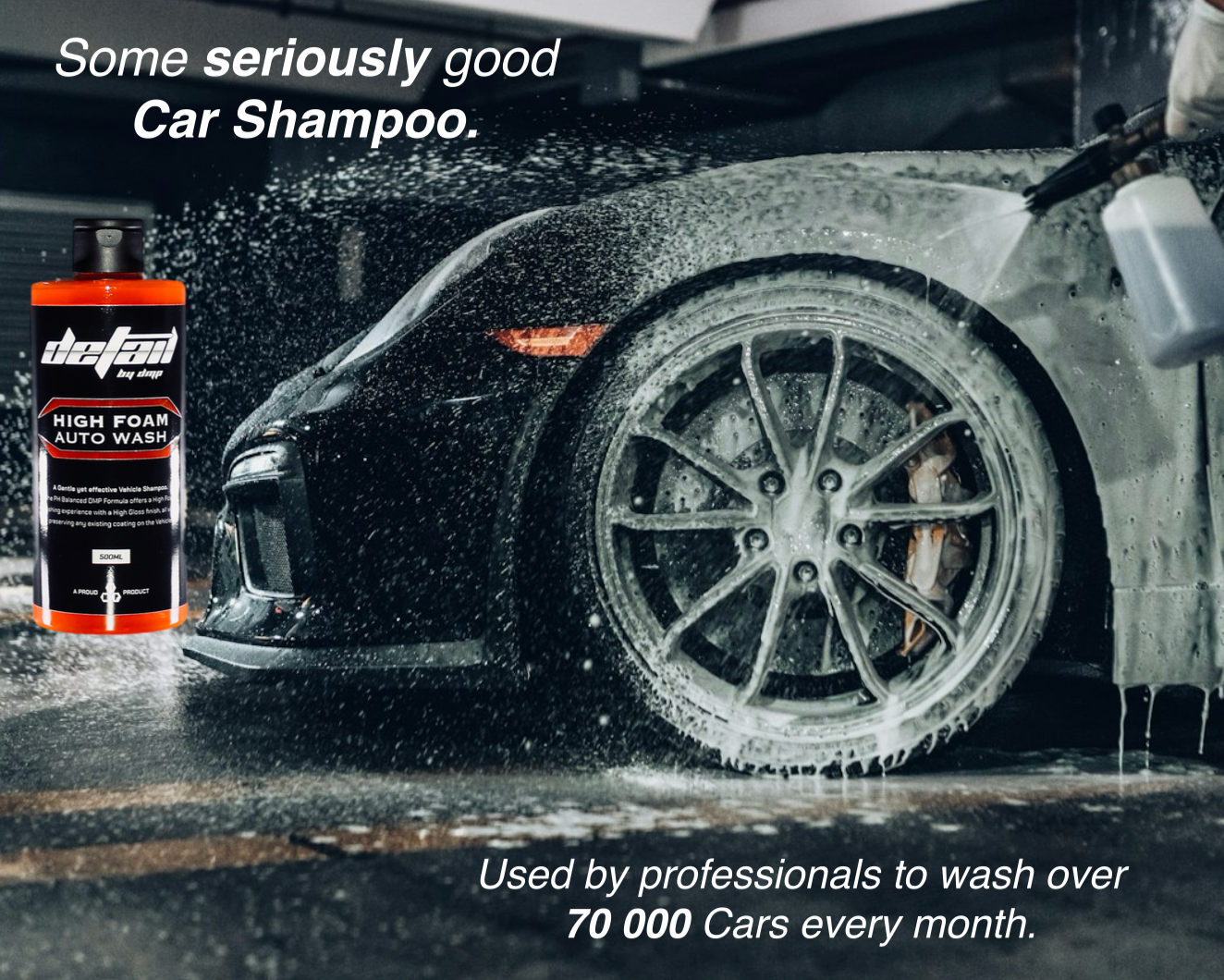 Car being washed with a bottle of detail car shampoo in the foreground.