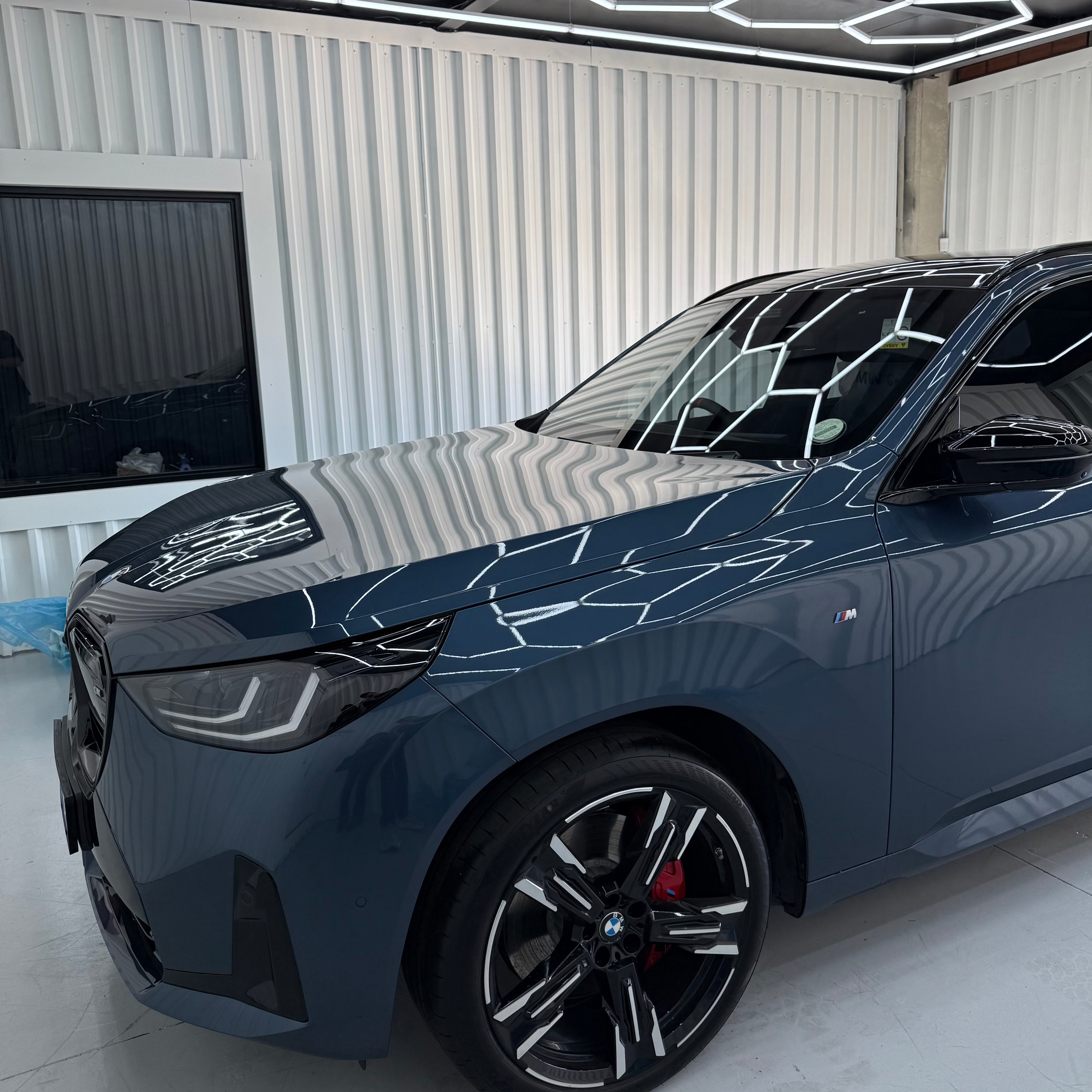 Black car with reflective surface in a showroom setting